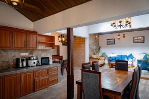 a kitchen and living room with a table and a dining room at Villa D55 - A Private Villa with Character & Comfort in Kandy