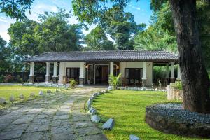 a house with a stone path in front of it at Villa D55 - A Private Villa with Character & Comfort in Kandy