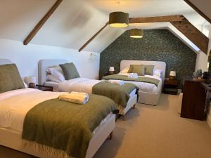a bedroom with two beds in a room at The Carpenters Tavern in Dundry