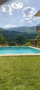 a swimming pool in the middle of a grass field at El Salón de Arriba in El Real de San Vicente