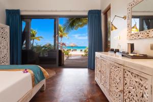 a bedroom with a bed and a view of the ocean at Golden Beach Resort in Koh Rong Island