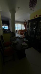 a living room with a table with plates on it at appartement pieds dans l'eau in Martil