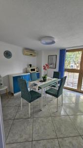 a dining room with a table and chairs at Apartmani Mediteran in Vrh +25 photos