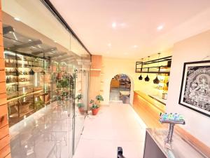 a store with glass doors and a hallway at Hotel Mums Home in Kathmandu