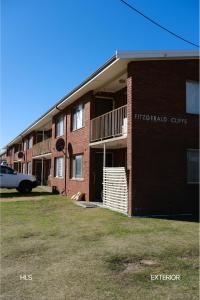 a brick building with a car parked in front of it at Harbour Lane Stay in Geraldton