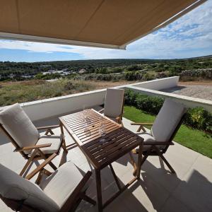 a patio with a table and chairs on a balcony at Sunrise & Sunset villa Šimuni by Pag tours in Šimuni