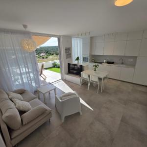 a living room with a couch and a table at Sunrise & Sunset villa Šimuni by Pag tours in Šimuni