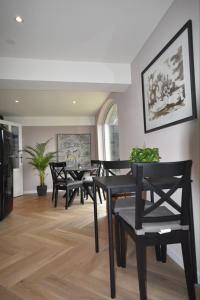 a dining room with black chairs and a table at De Vechthoeve in Dalfsen