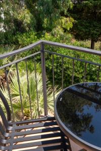 a bench and a table on a balcony at Beach House - Affittacamere Paola in Paola +11 photos