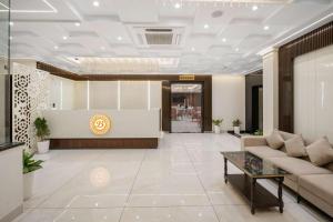 a lobby with a couch and a table at Hotel The Balram in Ayodhya