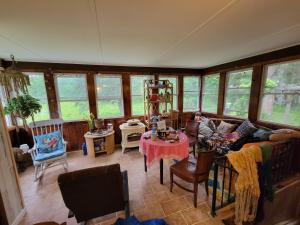 a living room with a couch and a table at Wine and roses farm house in Waymart