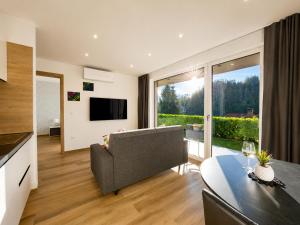 a living room with a couch and a table at Vila Katarina - Lake View Apartments in Bled