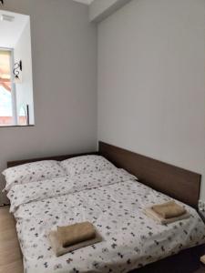 a bedroom with a bed with two pillows on it at Pokoje U Cyngla in Mielec