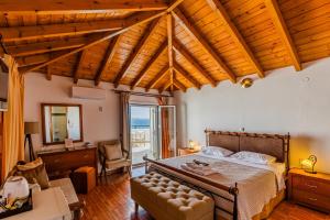 a bedroom with a bed and a desk and a chair at Filoxenia Hotel Monemvasia in Monemvasia