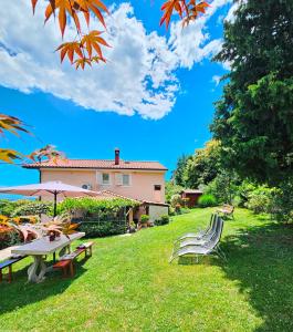 a picnic table and chairs in the yard of a house at Apartman Ruza 3 in Poljane +16 photos