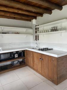 a kitchen with a sink and a counter top at Casa Fluila in Praia do Rosa +260 photos