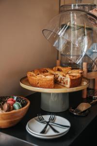 a plate of bread on a shelf with a cake at Hotel Sint Nicolaas in Amsterdam +64 photos