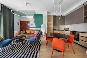 a living room with a couch and a table and chairs at BW Premium One-Bedroom Apartments in Belgrade