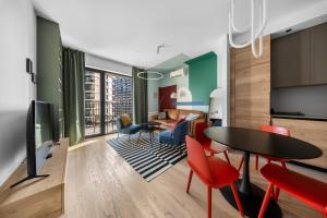 a living room with a table and chairs at BW Premium One-Bedroom Apartments in Belgrade