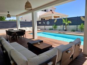 a living room with a couch and a swimming pool at Vila Esnella - Private Pool & Panoramic Sea view in Primošten