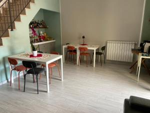 a dining room with two tables and chairs at La terrazza nel borgo in Tortora