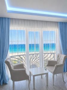 a living room with a view of the ocean at NOVA PORT Boutique Hotel in Tekirdağ