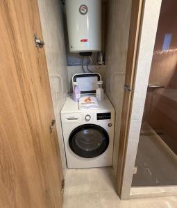 a washer and dryer in a small room at MANDARIN Luxury Suites in Asprovalta