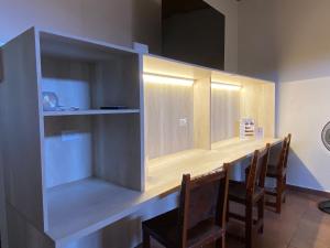a room with a counter with chairs and a table at La Villa Study & Relax Apartment in Los Santos