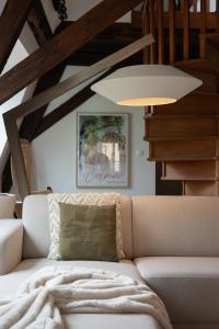 a living room with a couch and a lamp at Le JOLIE DUPLEX in Colmar +33 photos