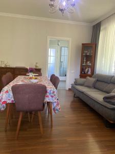 a living room with a table and a couch at Zurkas’ guesthouse in Batumi