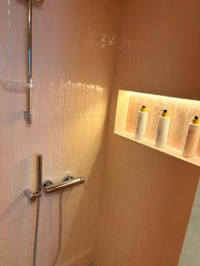 a bathroom with a shower with three rolls of toiletries at MANDARIN Luxury Suites in Asprovalta +31 photos