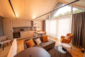 a living room with a couch and a kitchen at Felsenland Bergvillen in Dahn