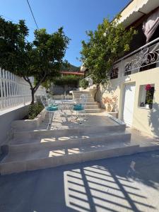 a group of tables and chairs sitting on concrete stairs at MANDARIN Luxury Suites in Asprovalta