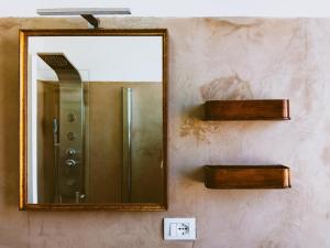a mirror on a wall in a bathroom at La Casina Tuscan Countryside View in Murlo +36 photos