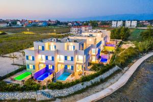 an aerial view of a white building with a swimming pool at Villa Miri Orchid in Privlaka