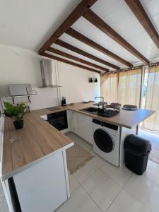 a kitchen with a counter and a stove top oven at Appartement ALYA in Les Trois-Îlets