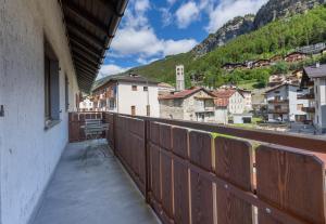 a balcony with a view of a town and mountains at Appartamento Petit Flower in Valdidentro