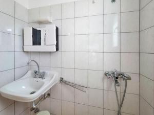 a white bathroom with a sink and a toilet at Europa Hotel Korinos in Korinos +23 photos
