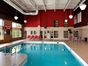 a large swimming pool in a large building at Ramada by Wyndham Trenton in Trenton