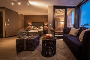 a hotel room with a bed and a couch at Skistar Lodge Hemsedal in Hemsedal