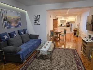 a living room with a blue couch and a table at SWINEMÜNDE Fewo Speckmann in Świnoujście
