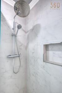 a shower with a shower head in a bathroom at Central Malta Gem - 3BR Apartment with Balconies in Mosta +25 photos