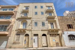 an old stone building windows and doors at Central Malta Gem - 3BR Apartment with Balconies in Mosta