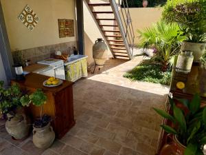 a kitchen with a counter and some potted plants at Cefalù Forest Hideout in Cefalù