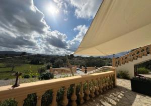 a view from the balcony of a house with an umbrella at Garden Suite Vila Girasoles in Cálig