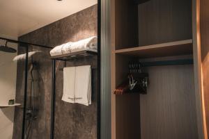 a bathroom with a shower and towels on a wall at Seawind Cloudcrest Resort in Semporna +145 photos