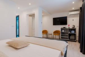 a bedroom with a bed and a tv on the wall at Matej's rooms in Korčula