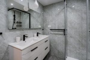 a bathroom with a white sink and a shower at Matej's rooms in Korčula +55 photos