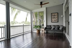 a living room with a couch on a porch at Mazecape in Ban Hua Khwai