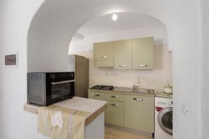 a kitchen with a sink and a stove top oven at Casa Gio & Angie in Forio d'Ischia